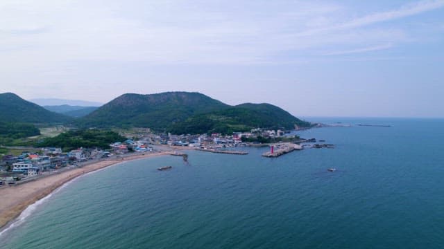 Coastal Village Nestled Between Mountains and Sea