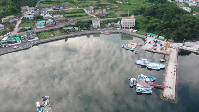 Farming and fishing village with anchored boats