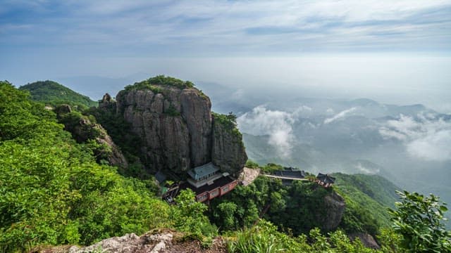 Mountain Temple Surrounded by Fog and Majestic Mountain Cliff