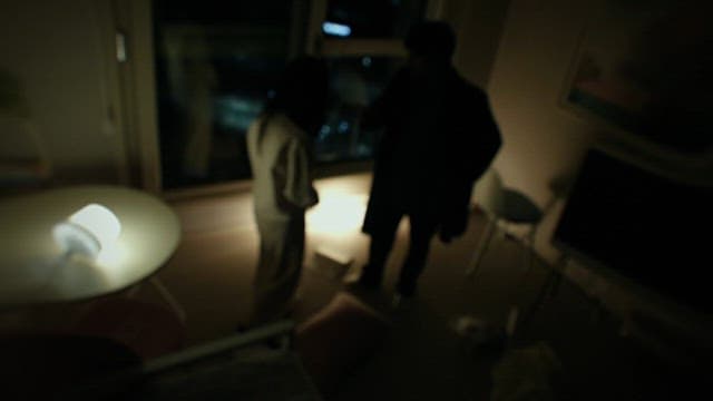 Man and Woman Talking in the Dark of the Living Room