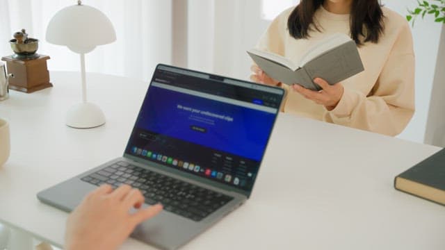 Two people enjoying leisure time at the white table in the living room