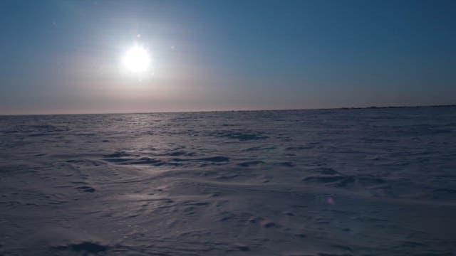 Arctic Landscape with the Sun Hanging Over the Horizon