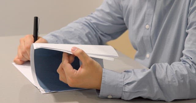 Taking Notes with a Pen on Company Business Materials