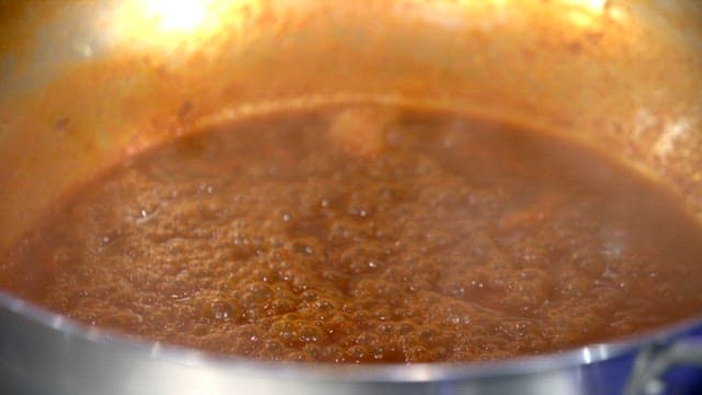 Spicy sauce simmering in a pot