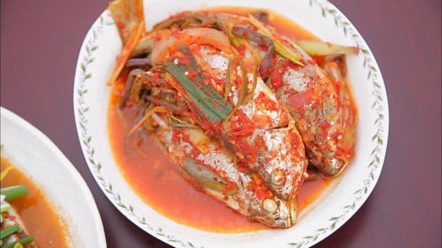 Braised yellow croaker on a plate on the table