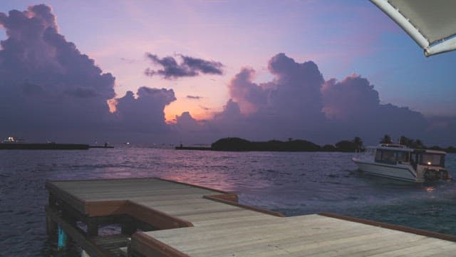 Serene sunset over the ocean with a boat