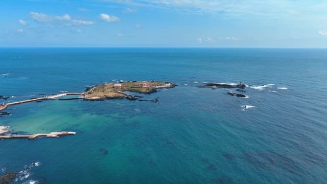 Small island surrounded by blue ocean