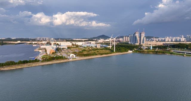 Cityscape with a river and wind turbines