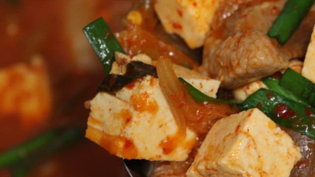 Kimchi stew with generous amounts of pork and tofu