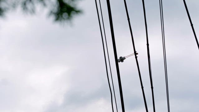 Power lines against a cloudy sky