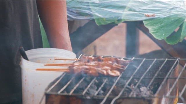 Grilling skewers on a charcoal grill