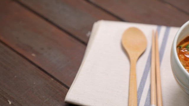 Bowl of spicy noodle soup plated on the table