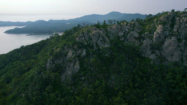 Scenic Rocky Mountain Range and Coastline at Dusk