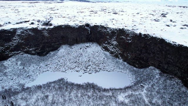 Snow-covered landscape with cliffs
