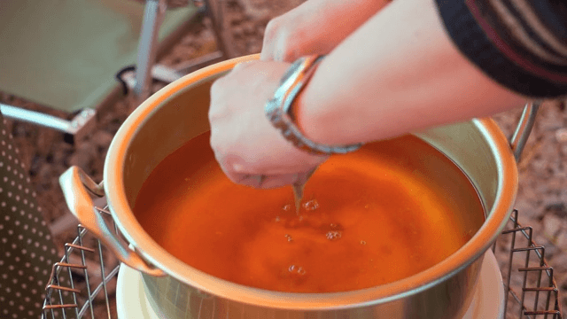Putting ramen base into a nickel-silver pot filled with water