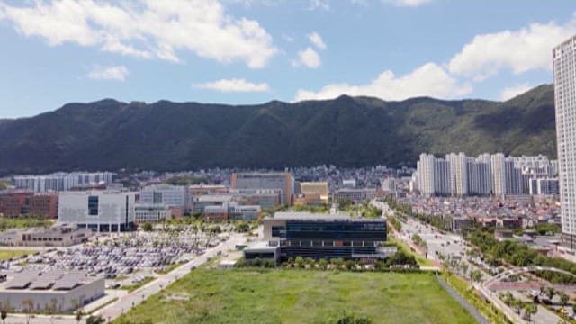 Aerial View of Urban Landscape Against Mountain Backdrop