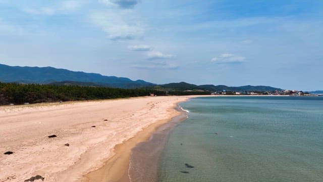Serene beach with distant mountains