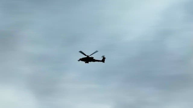 Helicopter flying in a cloudy sky