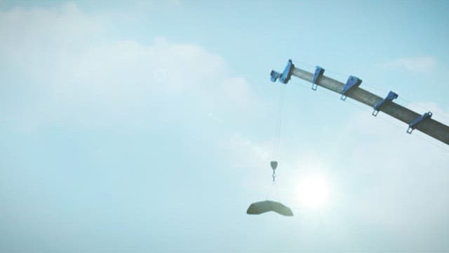 Crane lifting a heavy object under the sun in construction site