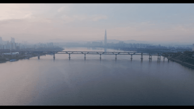 Serene river with a bridge and cityscape