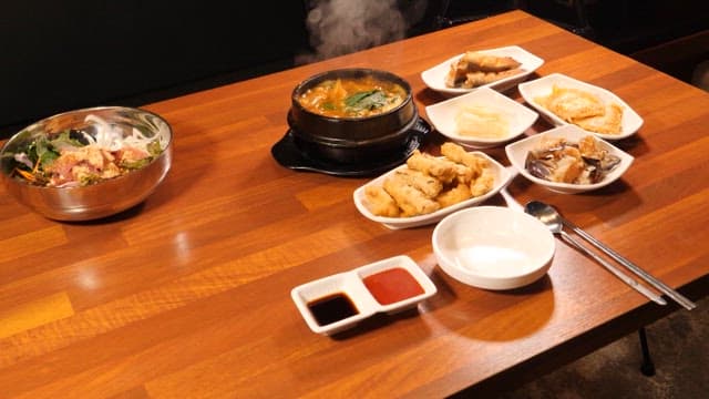 Table set with Korean dishes and sashimi