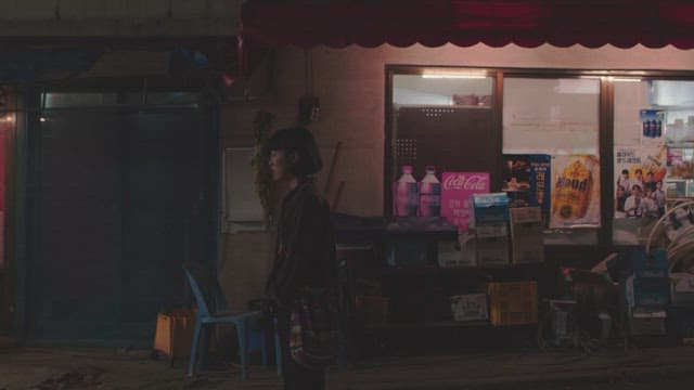 Night conversation between man and woman at a street-side store