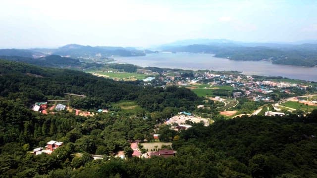 View of a countryside village next to a large lake
