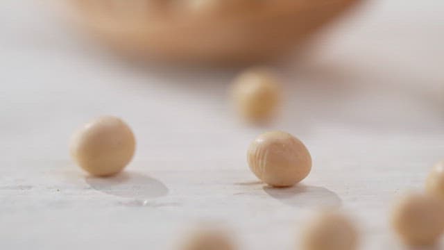 Fresh soybeans on a wooden spoon