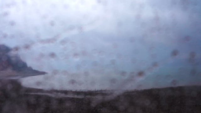 Horizon seen through a rainy and foggy window