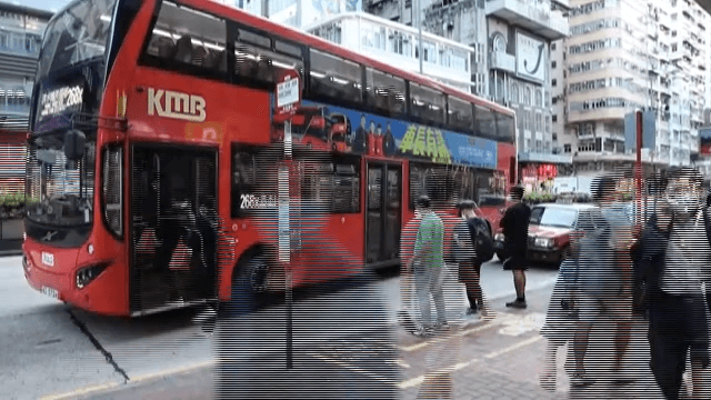 Bustling City Corner with Blurred Pedestrians