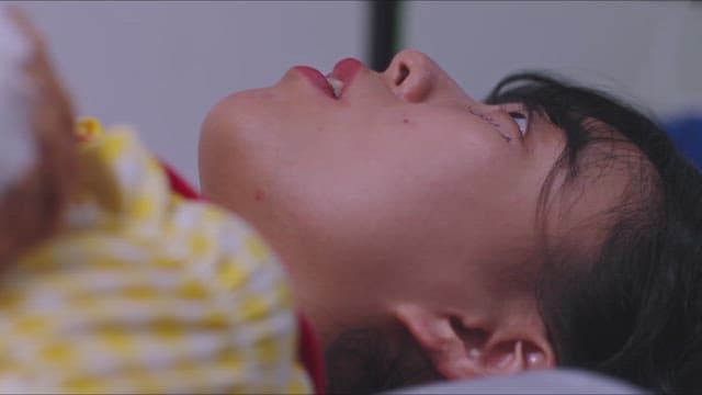 Woman lying in bed and staring blankly at the ceiling