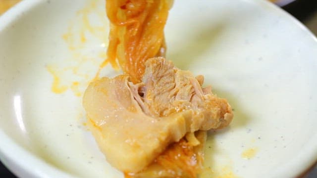 Kimchi and pork on a white plate