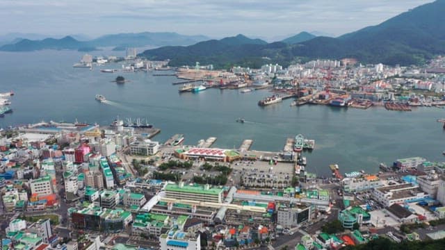Aerial view of a bustling coastal city with a harbor