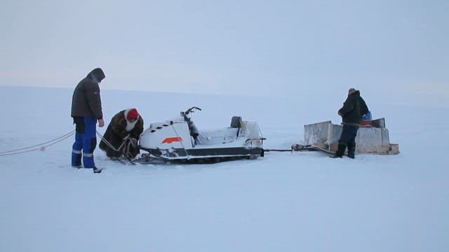 Winter Expedition Tying Snowmobiles to Large Vehicles