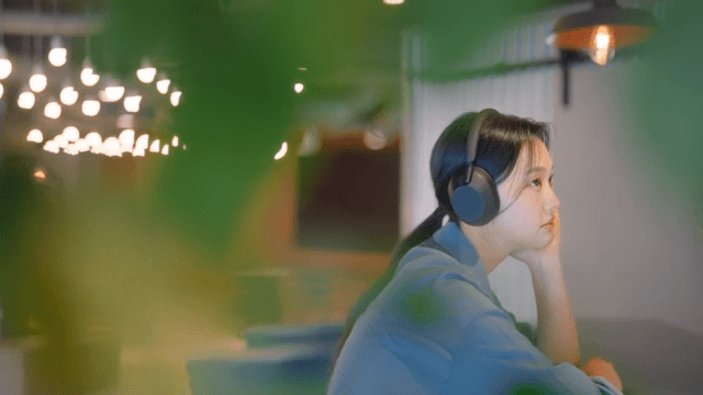 Woman enjoying music with headphones indoors