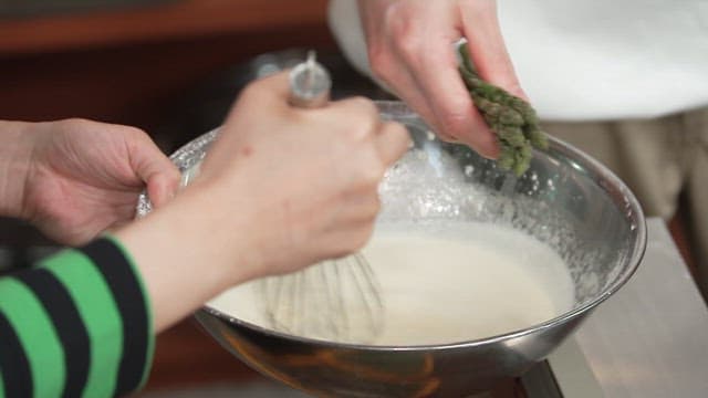 Asparagus Mixed with Batter for Frying in a Metal Bowl