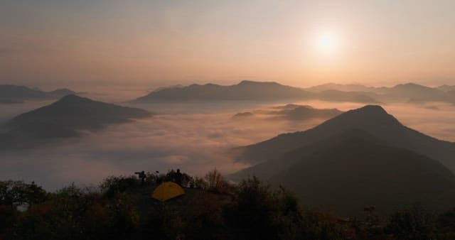 Sky Colored by Sunrise over Foggy Mountains