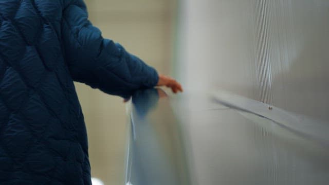 Man in a blue jacket taking a subway escalator