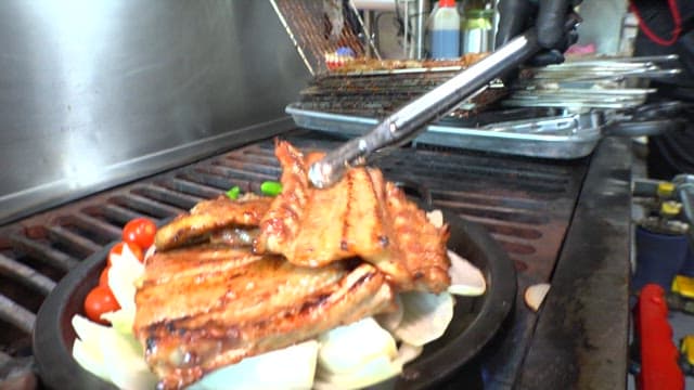 Grilled galbi on a hot iron plate on top of onions