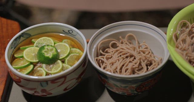 Bowls of Noodles and Lime Slices Prepared