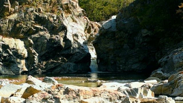 Water flowing along rugged coastal rocks
