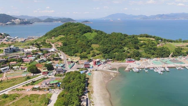 Coastal village with lush green hills