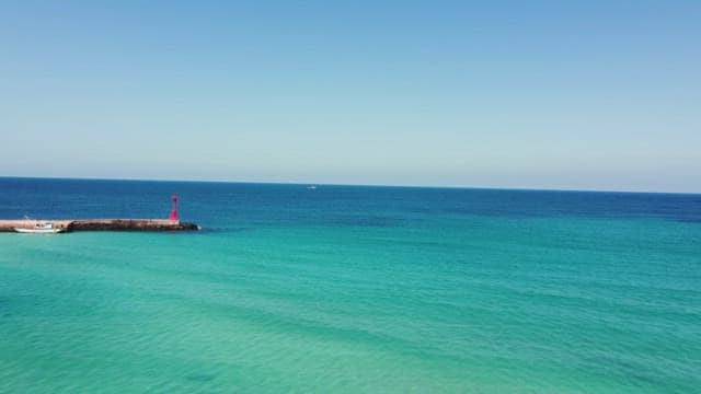 Calm sea with a distant lighthouse