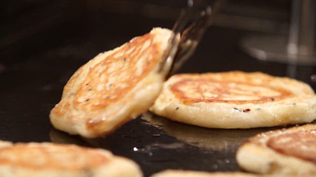 Korean hotteok cooking on a griddle