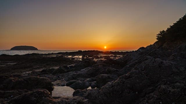 Sunset over a rocky shoreline