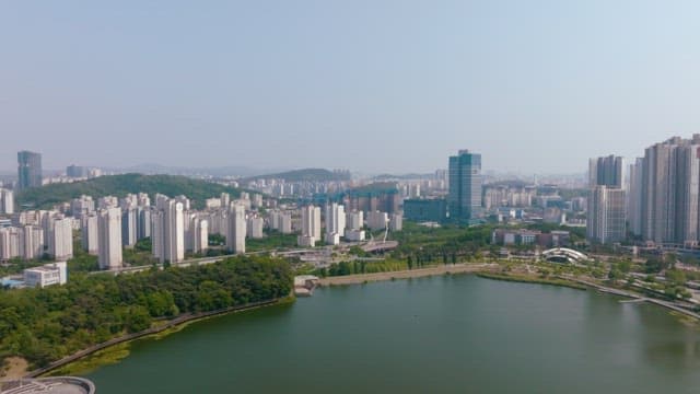 Aerial view of a city with high-rise buildings and a lake
