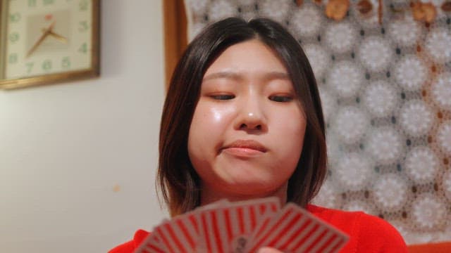 Woman playing cards indoors