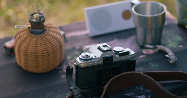Camera and Speaker Placed on a Camping Table