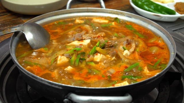 Stew with lots of vegetables and meat is boiling