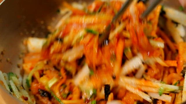 Mixing fresh cold raw fish soup with red pepper paste